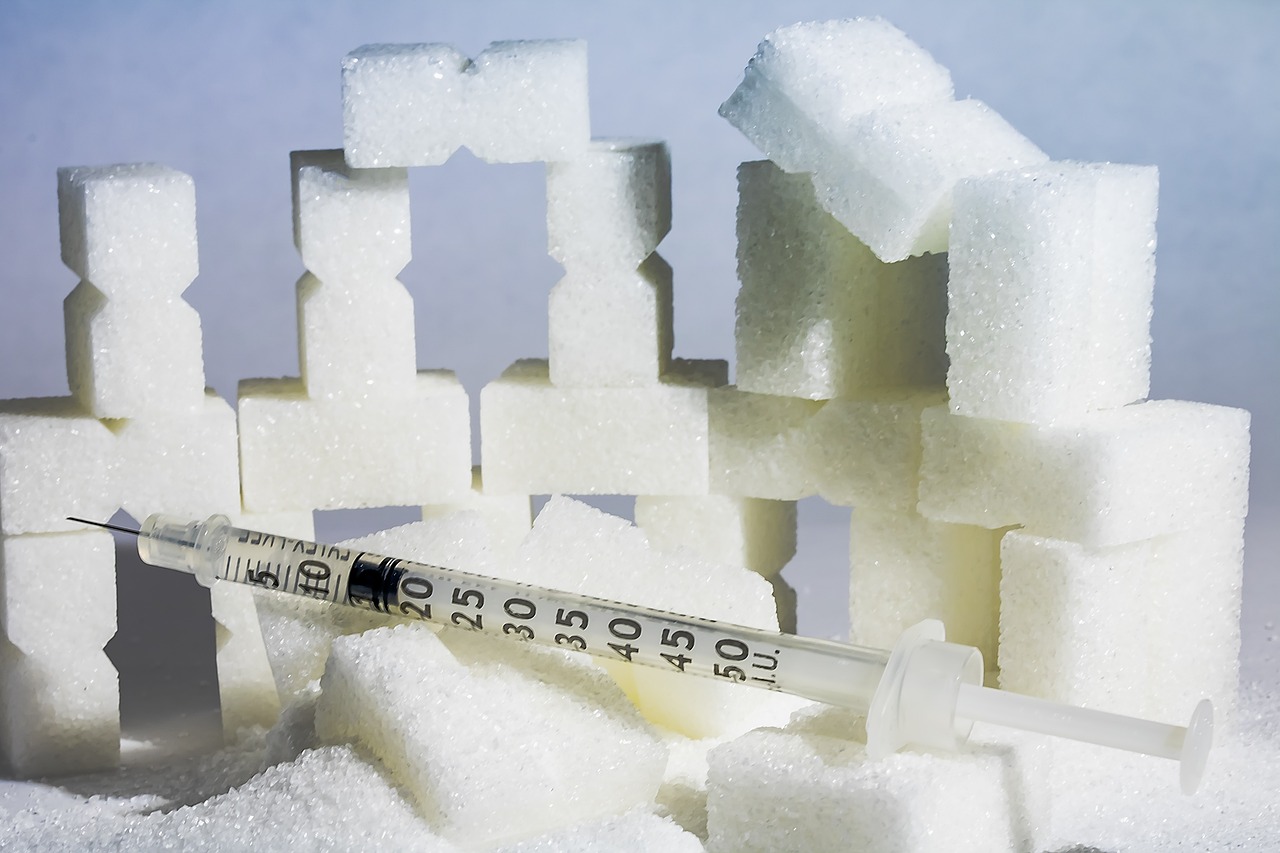 Depiction of sugar and insulin syringes, suggestive of diabetes.