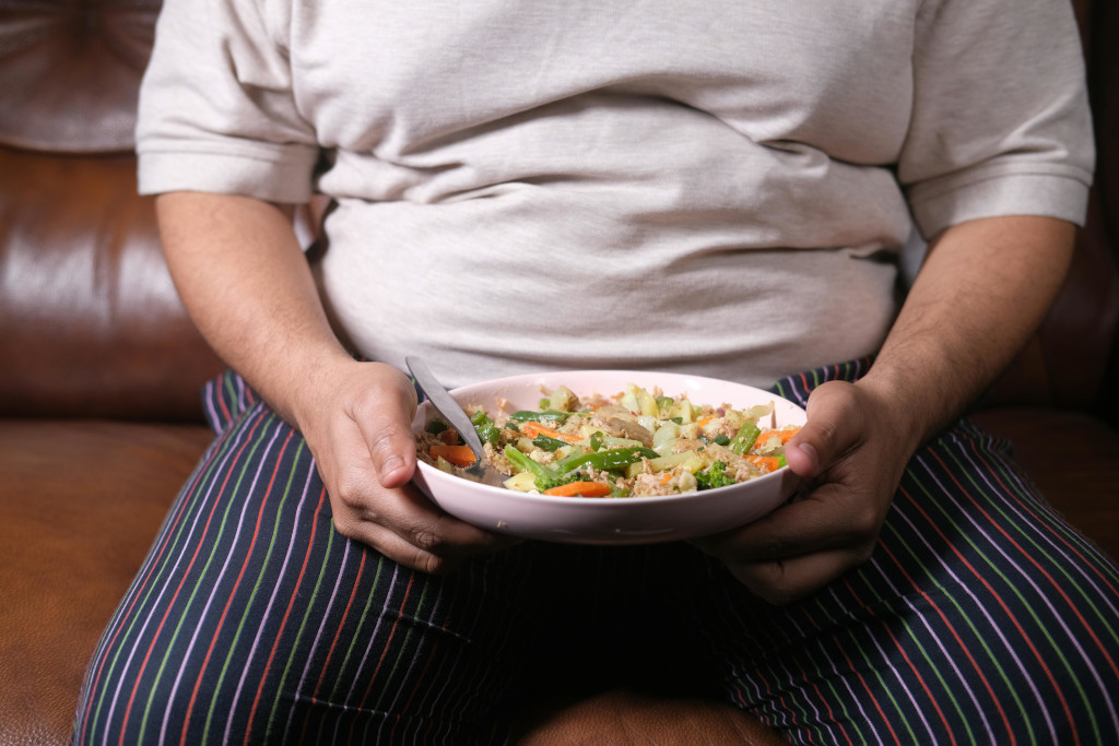 Person holding a bowl of healthy food. Source: https://www.pexels.com/photo/person-holding-a-bowl-of-food-with-spoon-11716934/